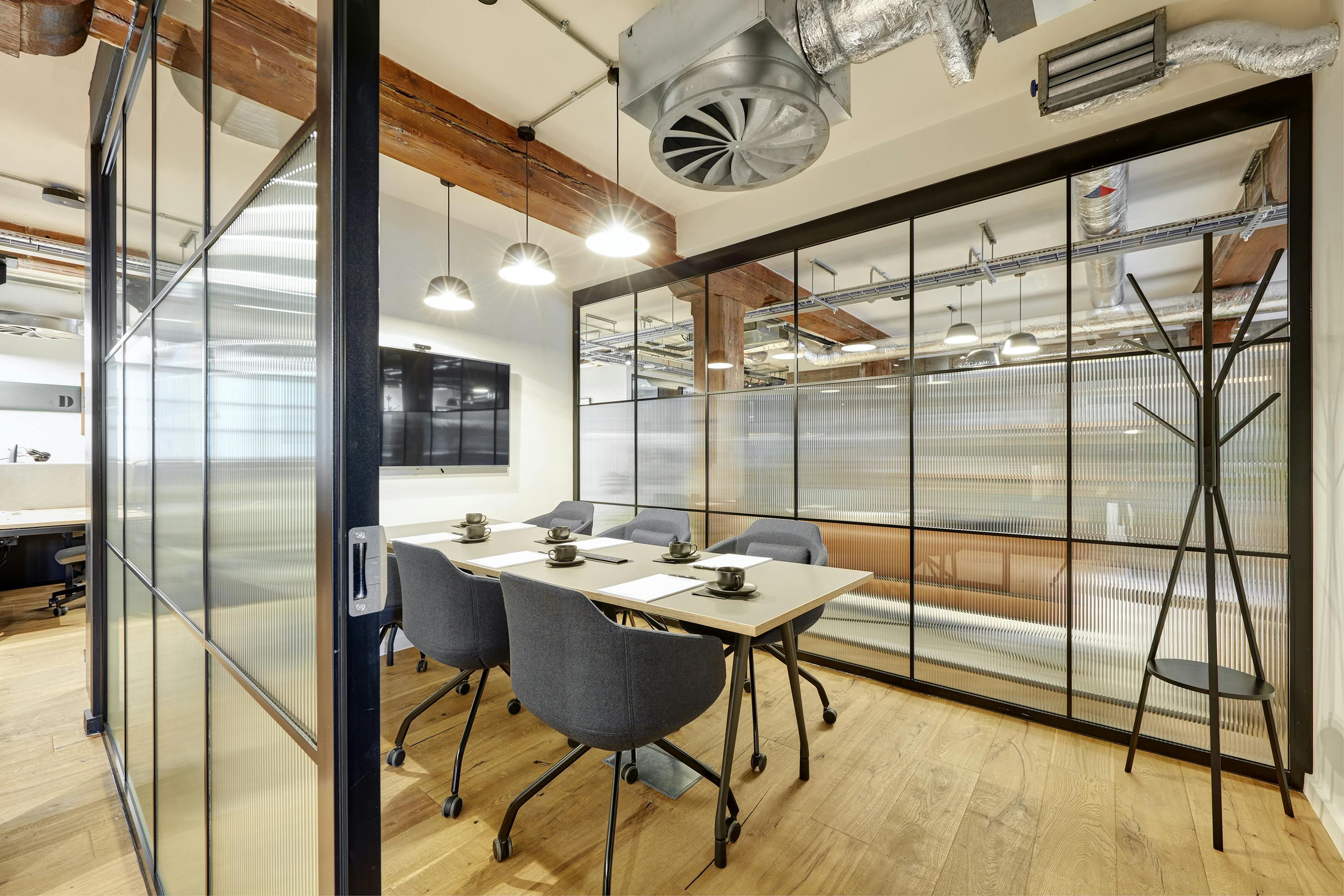 Modern meeting room M1 in Clockwise Edinburgh Leith, featuring glass walls for collaboration.