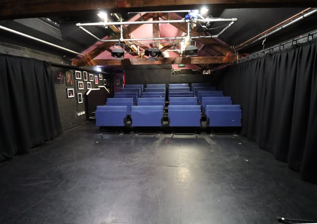 Versatile event space with tiered seating at Pleasance Theatre for workshops and performances.