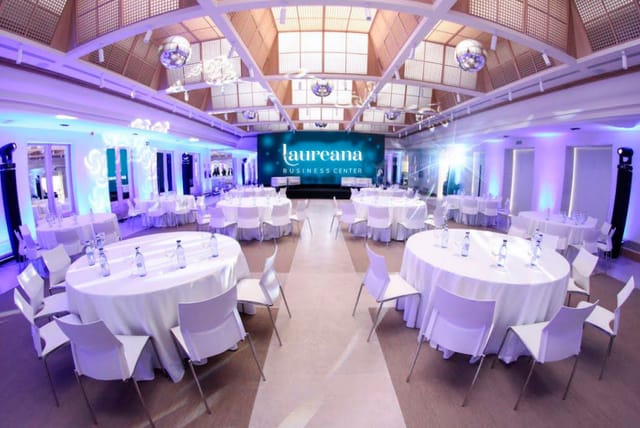 Granja room at Laureana Business Center, elegant conference space with round tables.