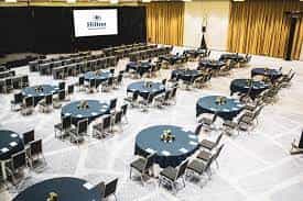 Symphony Ballroom at Hilton Miami: elegant conference space with navy tables and centerpieces.