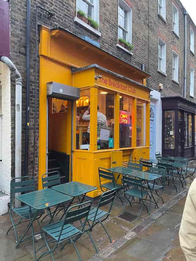 Vibrant yellow café exterior, ideal for casual networking events and brunch meetings.