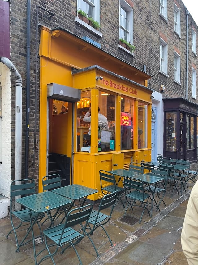 Vibrant yellow café exterior, ideal for brunch meetings and casual networking events.