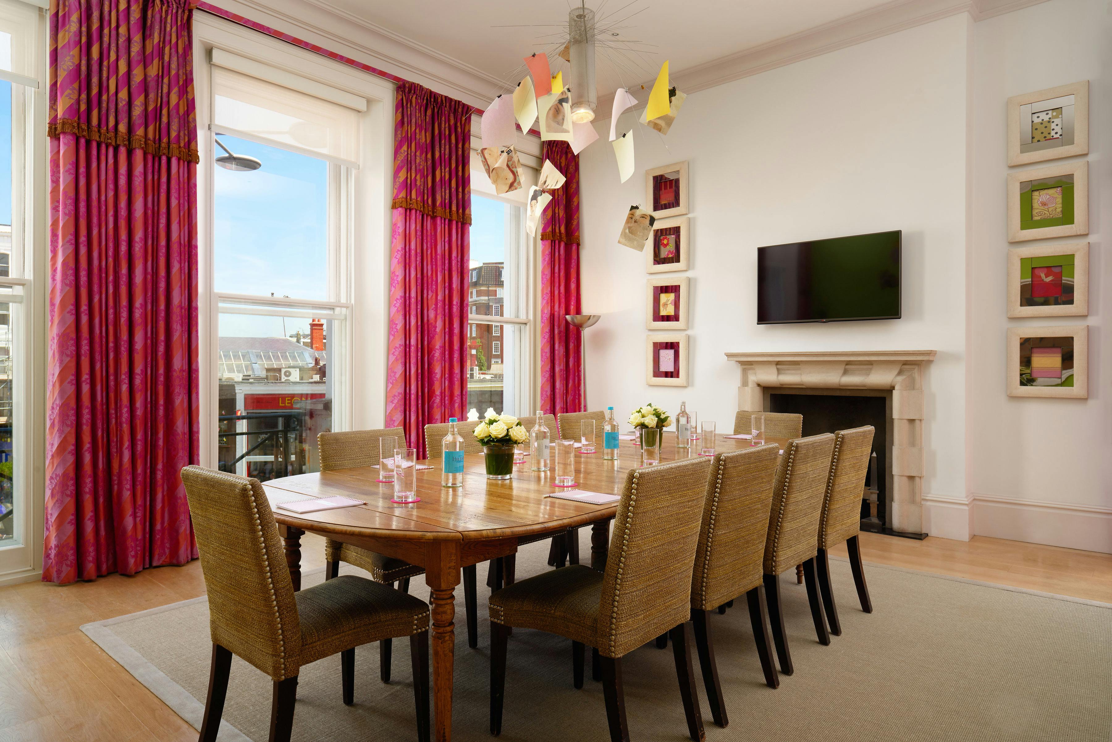 Meeting room at The Pelham Hotel with a large wooden table for collaborative events.