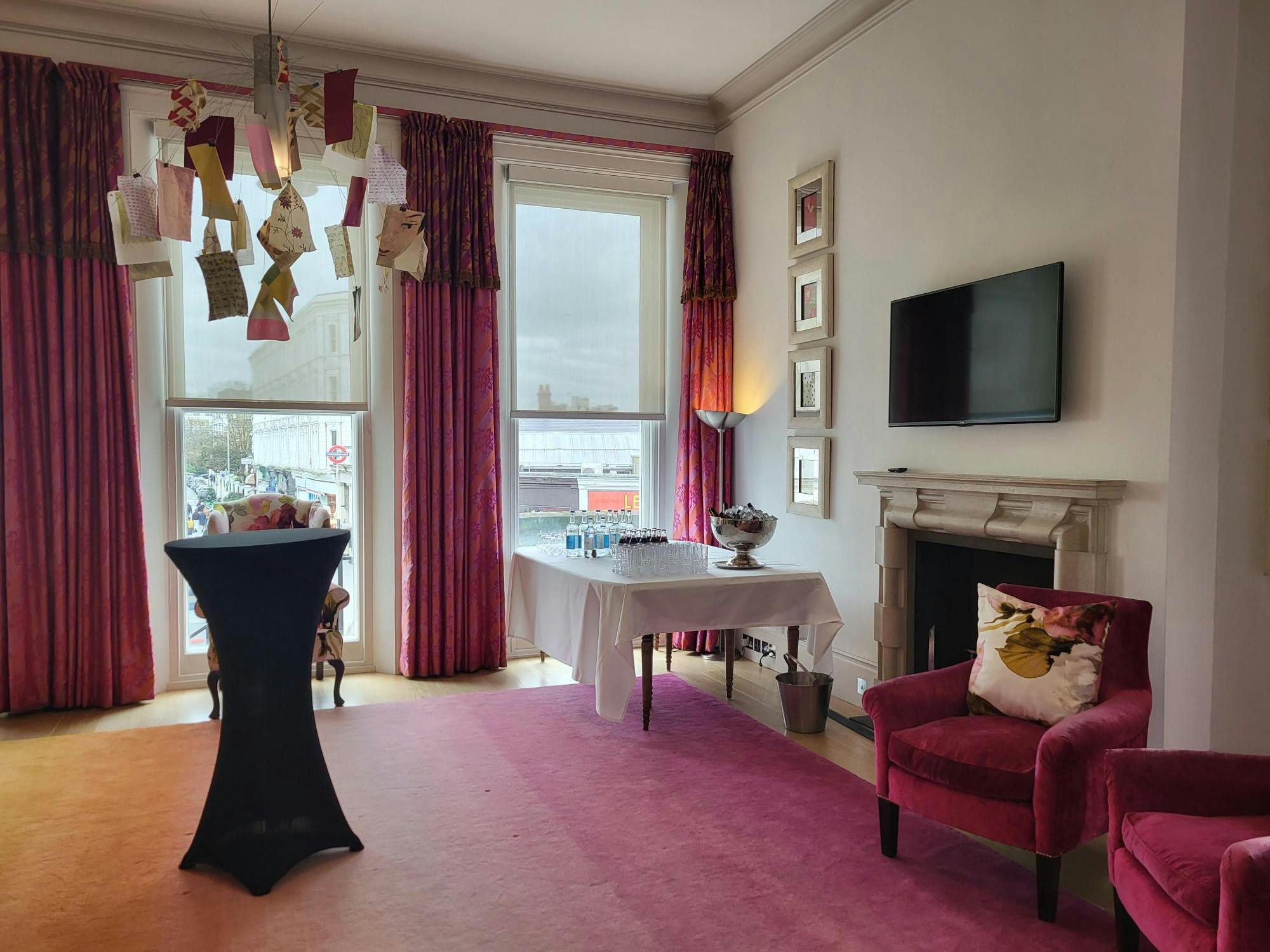 Stylish meeting space at The Pelham Hotel with vibrant curtains for intimate gatherings.