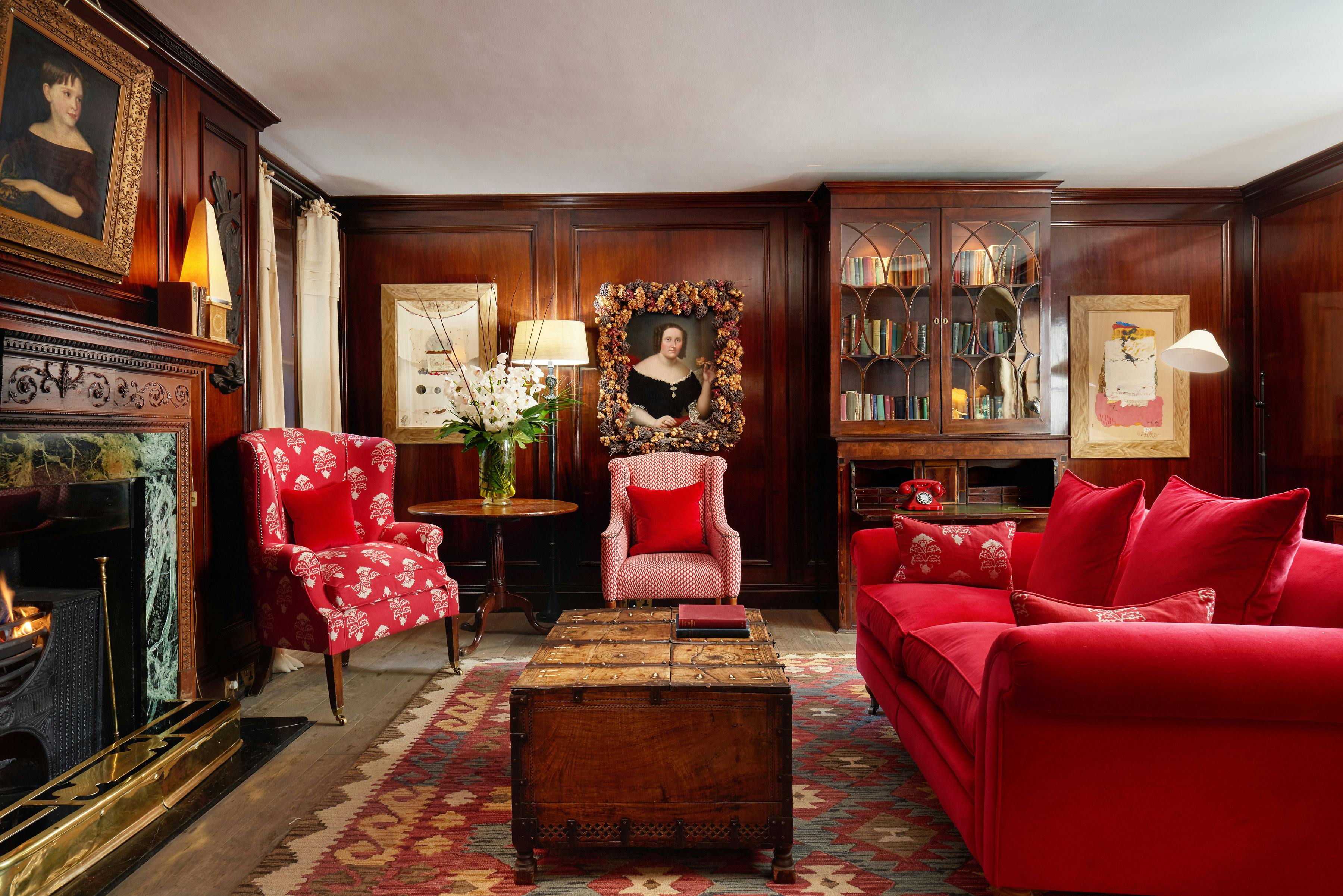 Sophisticated meeting space in The Pelham Hotel with rich wood paneling and cozy fireplace.