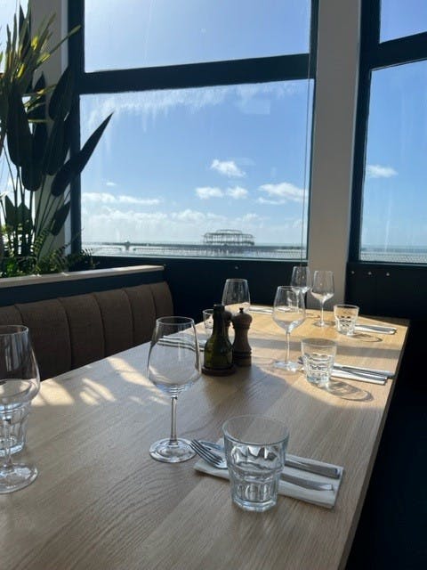 Elegant dining table with waterfront view at Upstairs Restaurant, ideal for events.