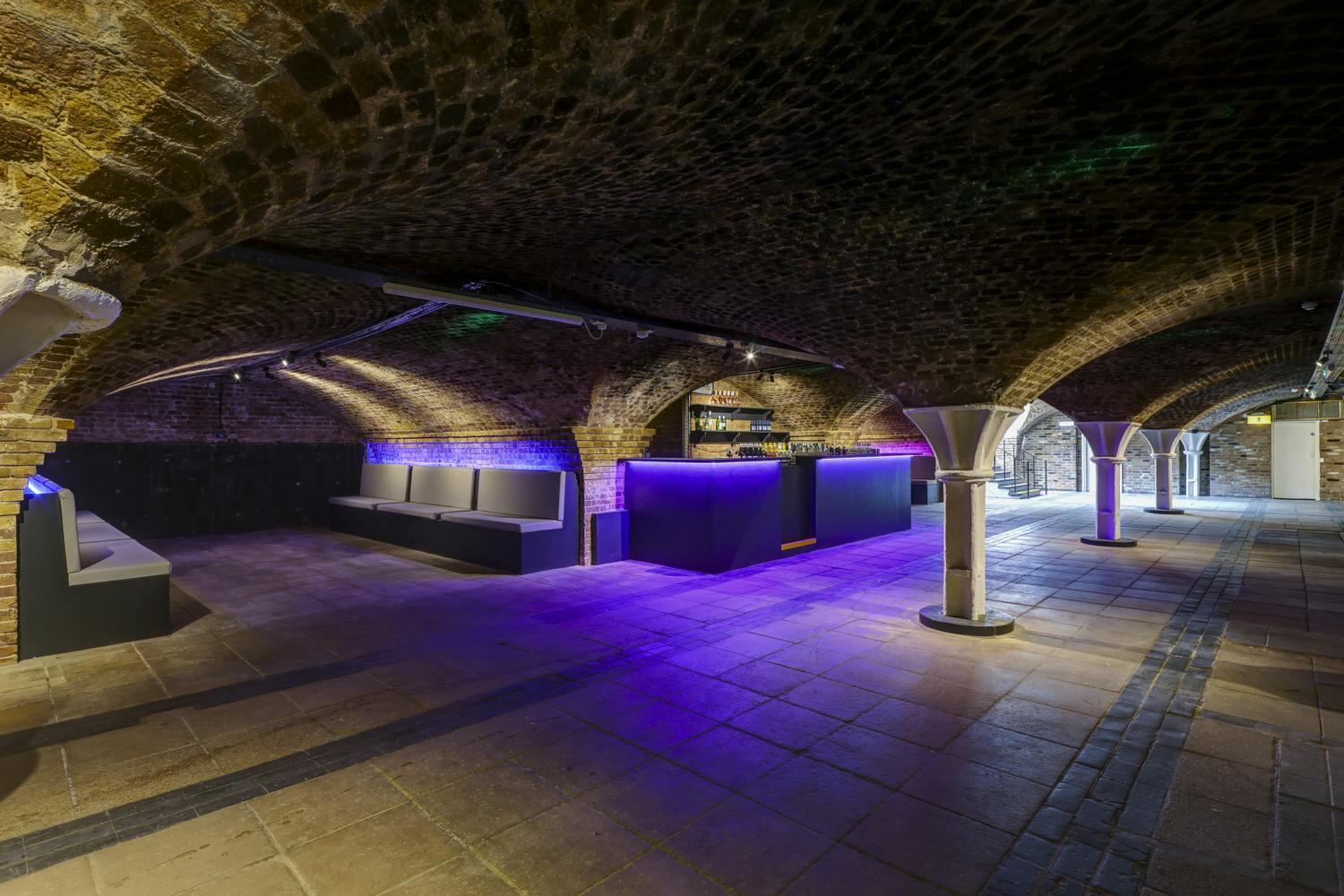 Versatile Dockside Vaults venue with exposed brick arches for corporate events and celebrations.
