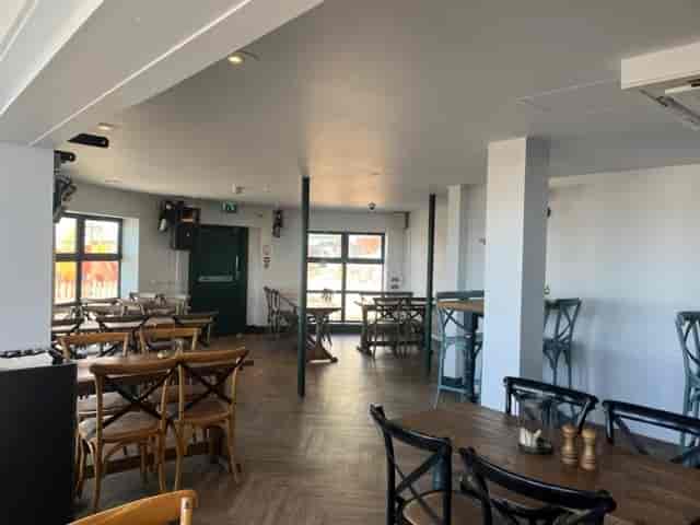 Versatile event space with natural light, ideal for gatherings and meetings.