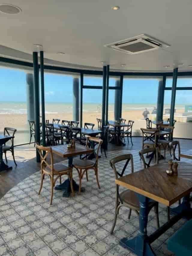 Beachfront venue at The Seahorse with wooden tables for workshops and networking events.