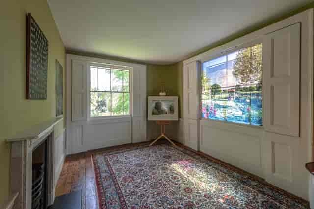 Elegant meeting space in Turner's House with large windows, perfect for gatherings and workshops.
