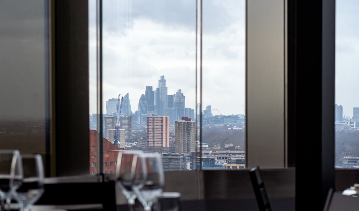 "Upscale event space at STK Rooftop Stratford with urban skyline view and elegant decor." - Banner