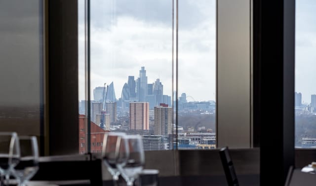 "Upscale event space at STK Rooftop Stratford with urban skyline view and elegant decor."