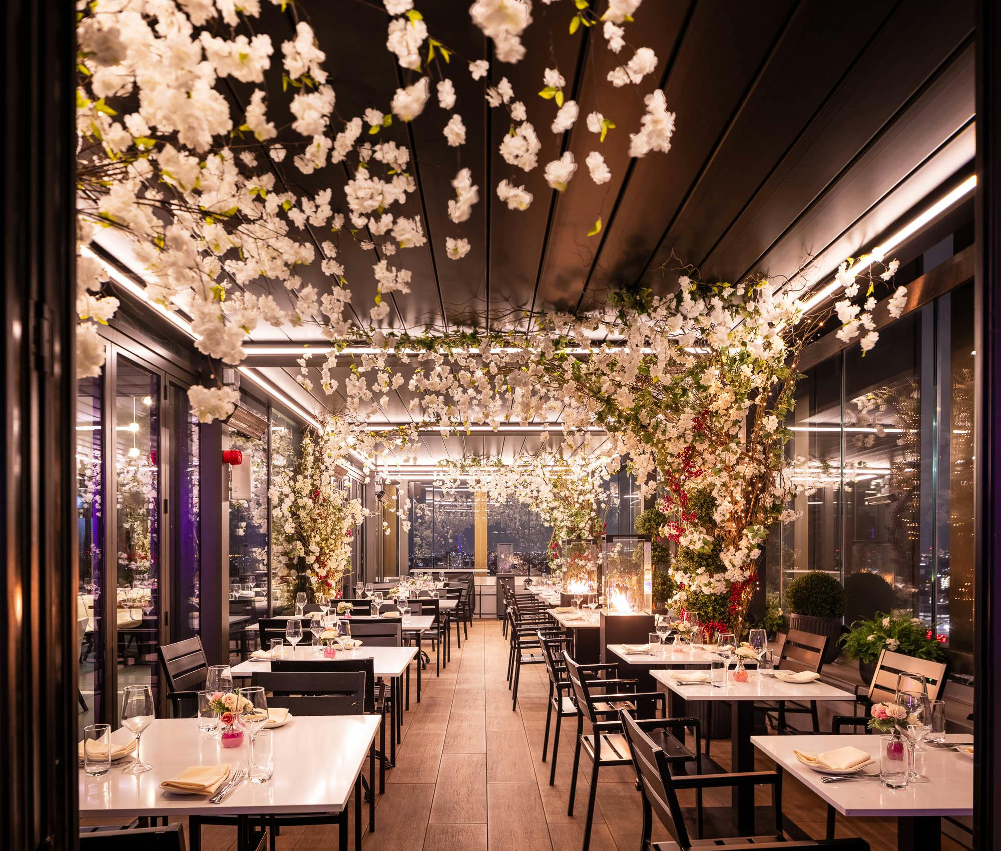 Elegant floral decor in STK Rooftop Stratford's East Terrace event space.