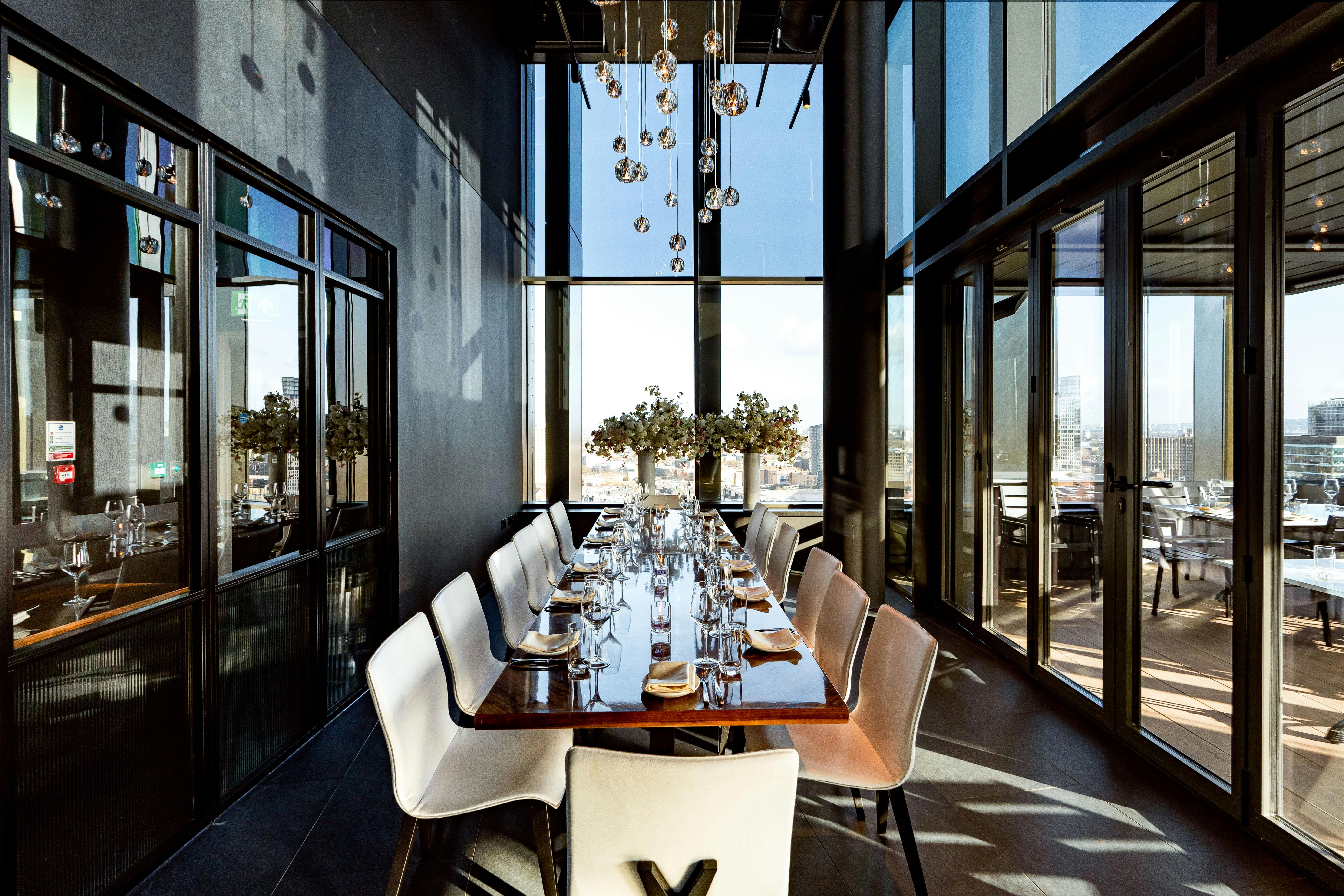 Private dining room with elegant table and views at STK Rooftop Stratford for events.