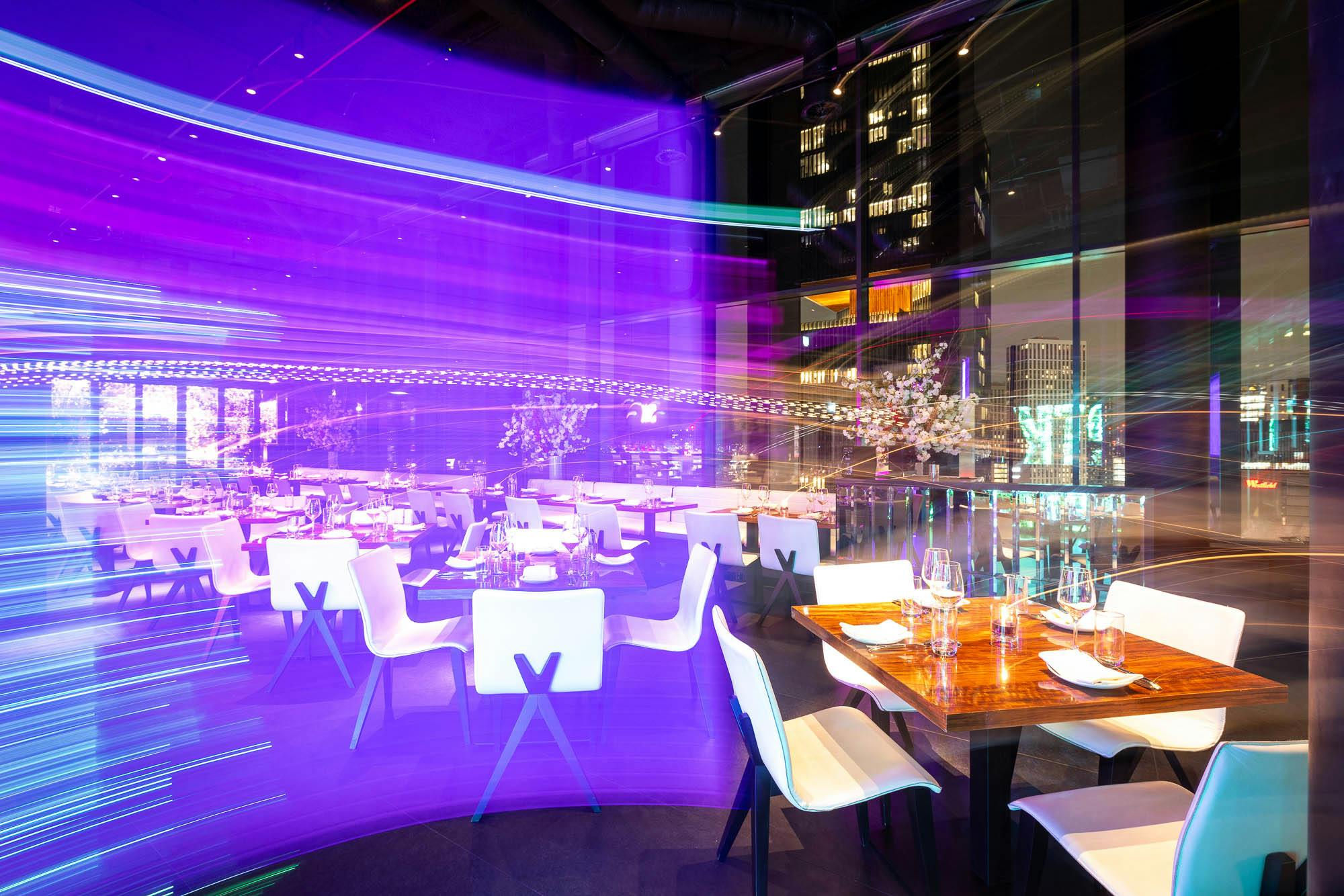 Modern event space at STK Rooftop Stratford with vibrant lighting for upscale gatherings.