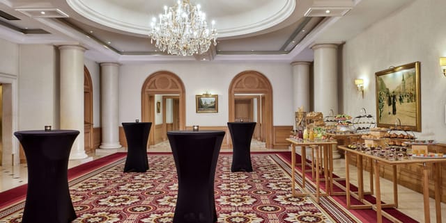 Elegant event space in Paris Marriott with chandelier, perfect for receptions and meetings.