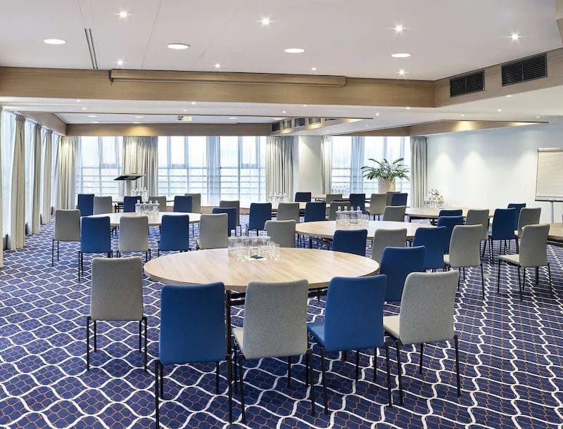 Meeting room at Radisson Blu Amsterdam with round tables for conferences and workshops.