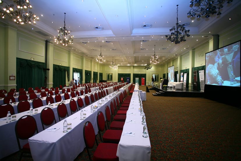 Conference room with red chairs at Indaba Hotel for corporate events and seminars.