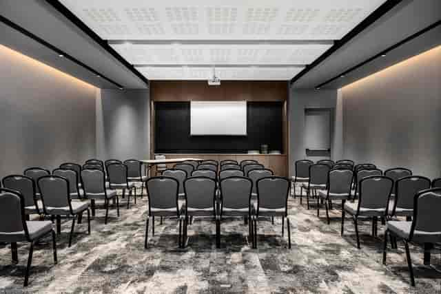 Modern meeting room with black chairs for workshops at Johannesburg Marriott Hotel.
