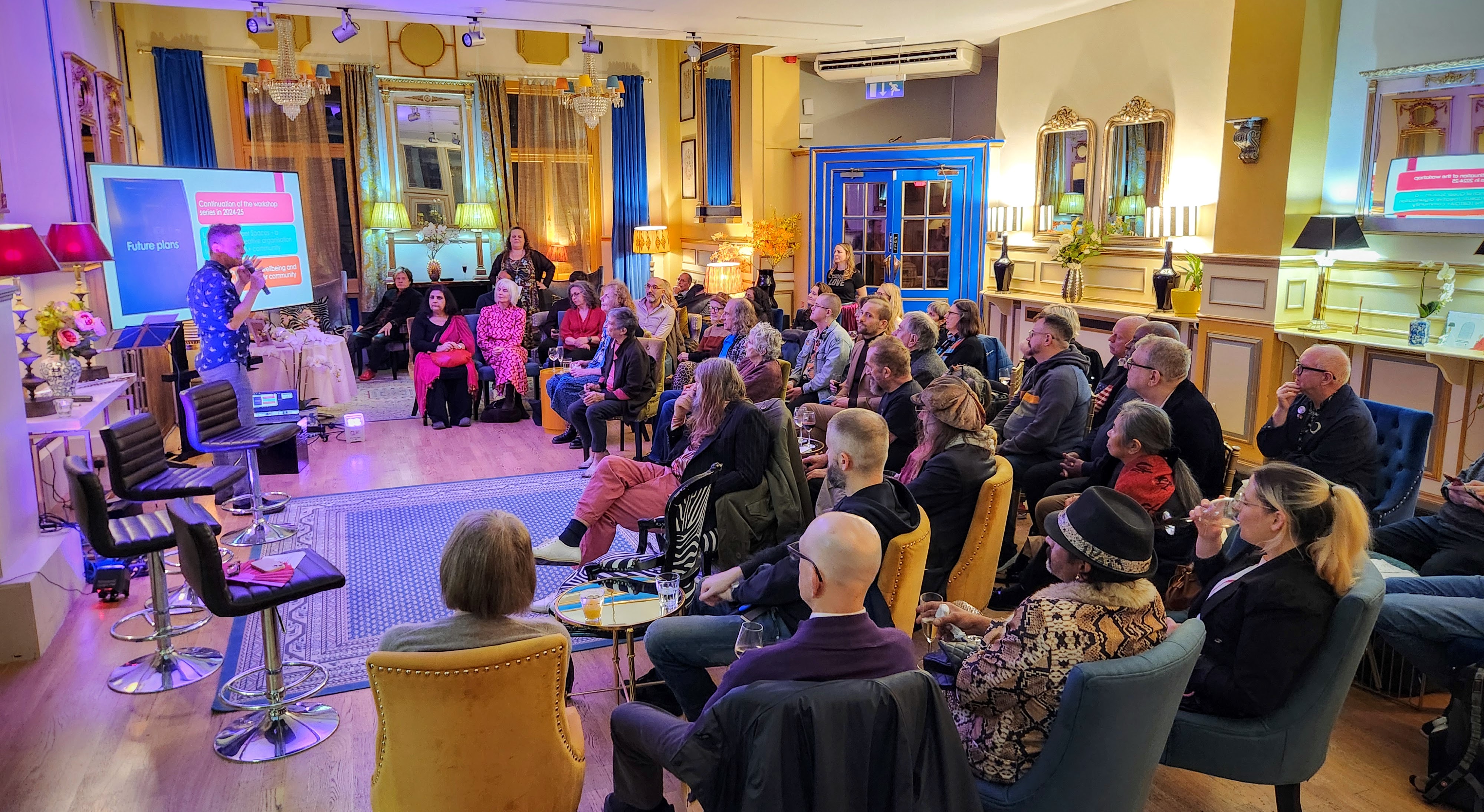 Embassy networking event, warm lighting, presentation, London - Banner