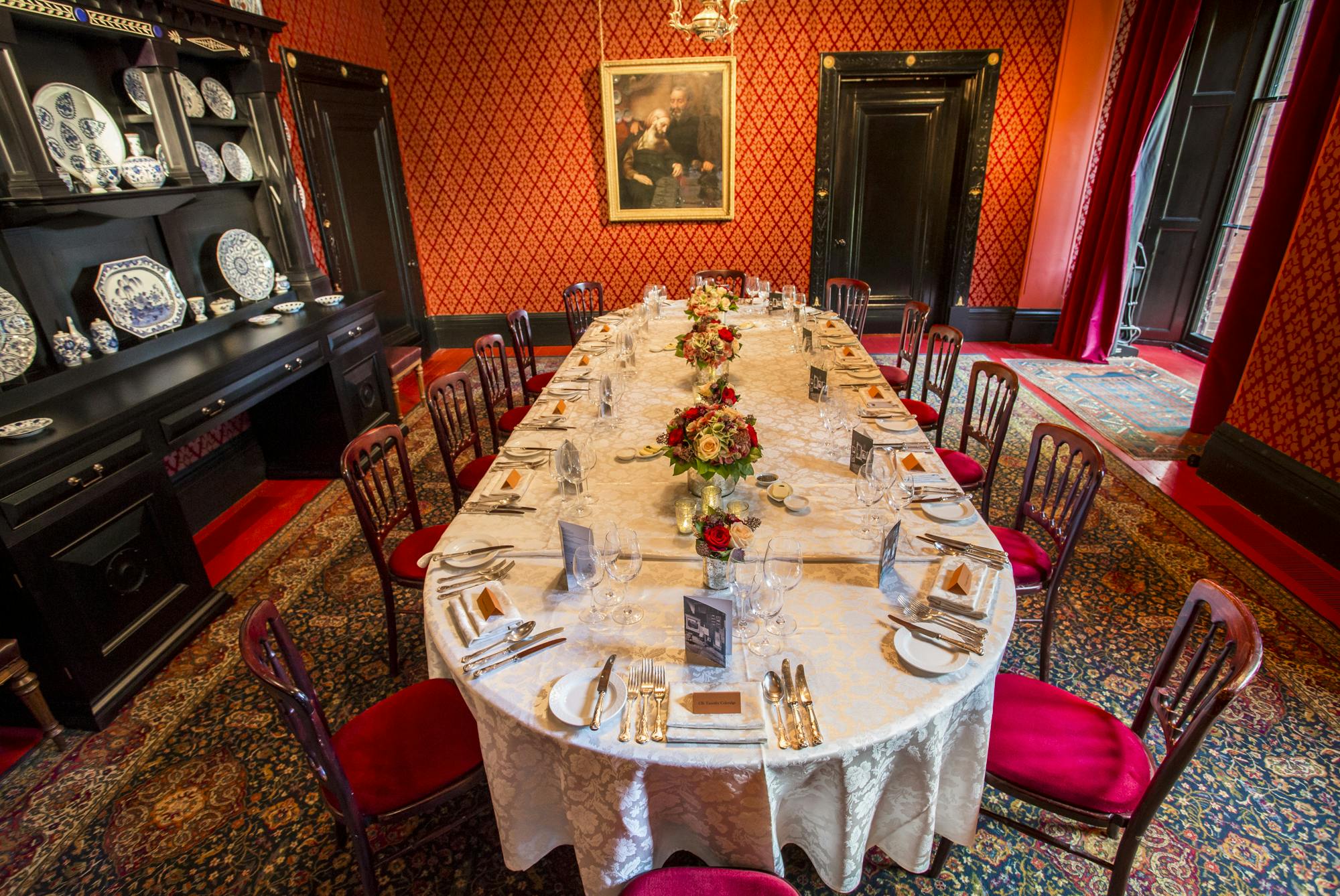 Elegant dining room at Leighton House with floral centerpieces for formal events.