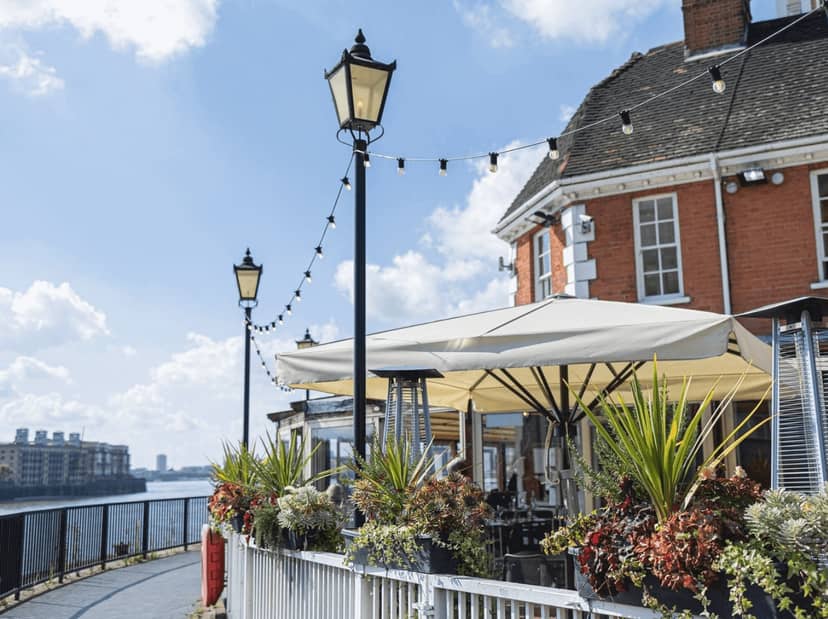 Charming outdoor terrace at Bread Street Kitchen, ideal for events by the waterfront.