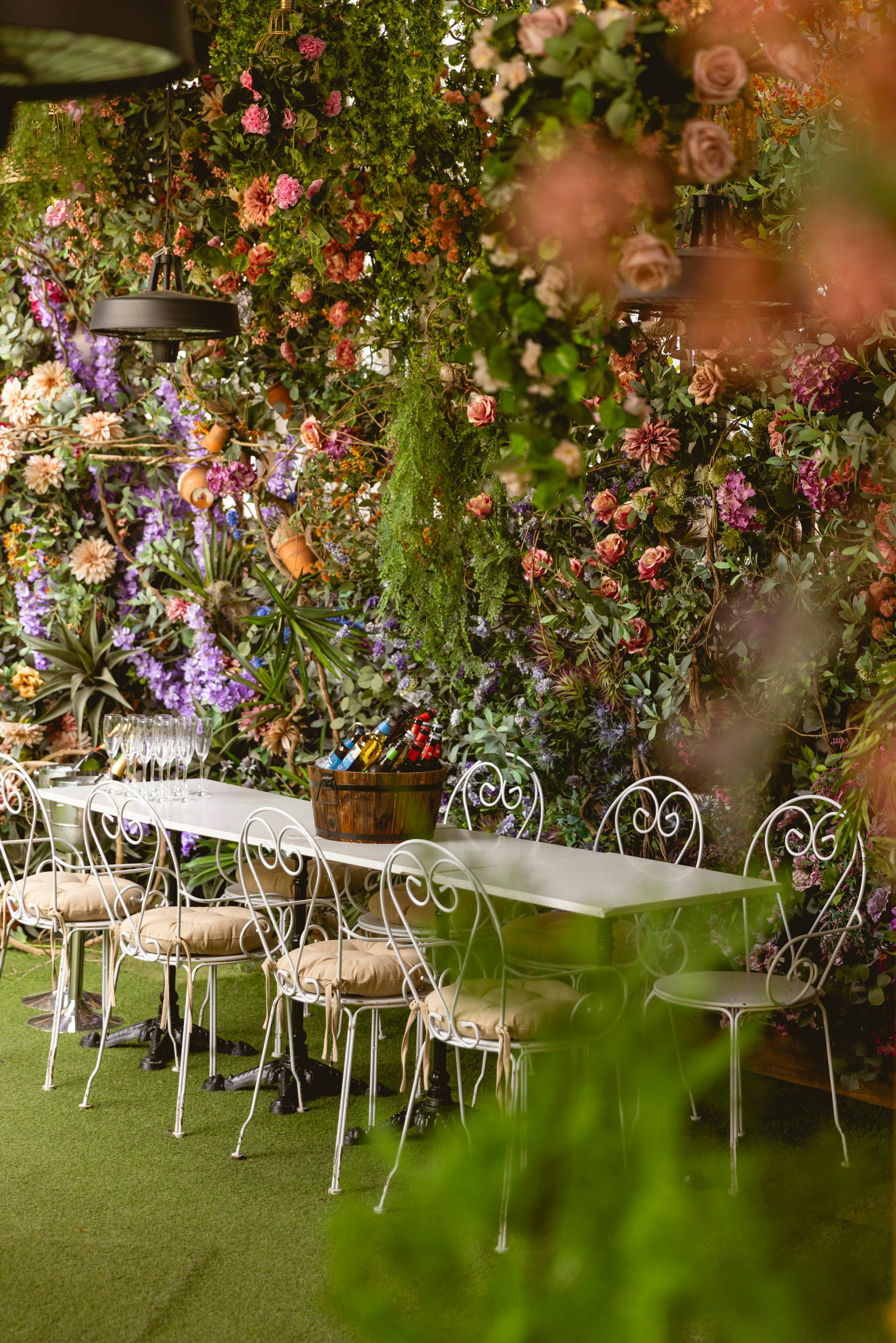 Mr Fogg's Secret Garden outdoor venue with floral backdrop for upscale events.