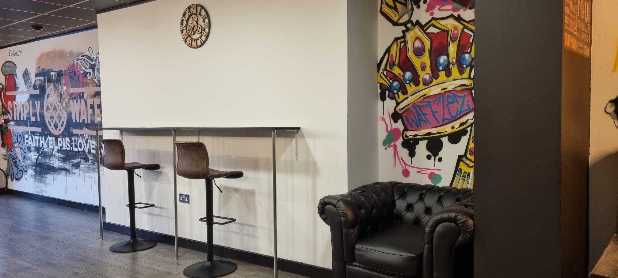 Modern meeting space with bar-height table and stools, perfect for networking events.
