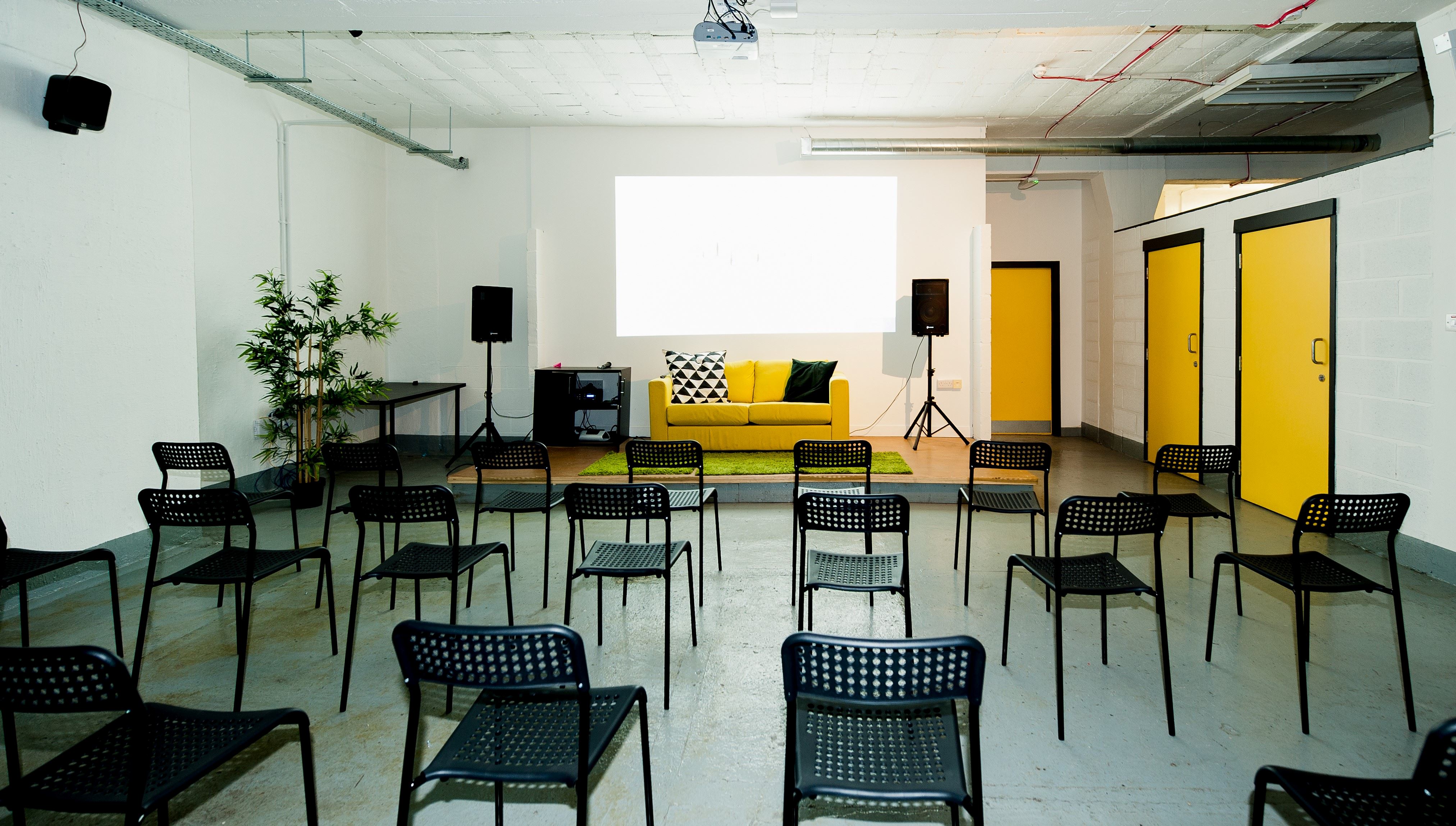 Basement Event Space at Box Studios with yellow wall, perfect for workshops and meetings. - Banner