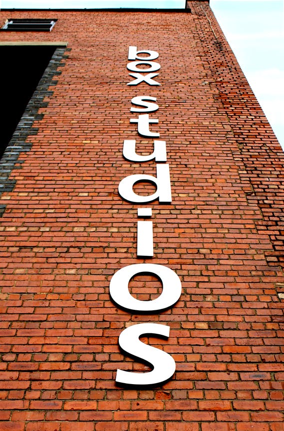 Basement Event Space at Box Studios with modern brick wall signage for creative gatherings.