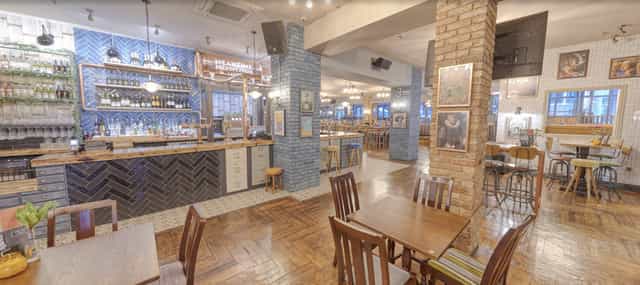 Stylish event venue with modern bar and ample seating for gatherings in The Alice.