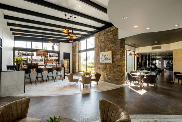 Modern event venue with natural light and stylish seating at Seven Villa Hotel & Spa.