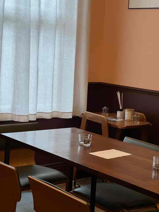 Cozy private dining room with natural light, perfect for intimate meetings and gatherings.
