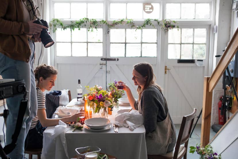 Intimate dining setup with floral centerpiece in North London Green Photographic Studio.