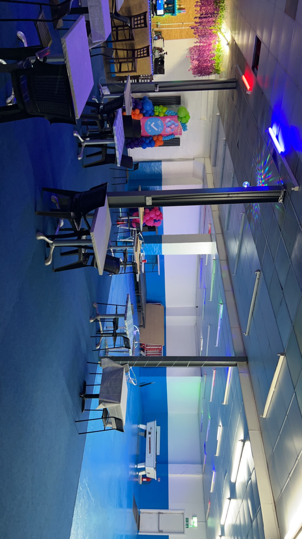 Blue Tick Bar and Grill event space with blue flooring for meetings and gatherings. - Banner