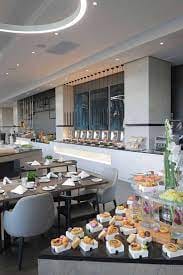 Modern event space at The Capital On The Park Hotel with buffet setup for conferences.