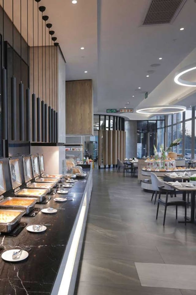 Modern event space at The Capital On The Park Hotel with buffet setup for corporate gatherings.