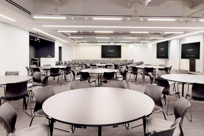 Versatile event space with round tables for meetings at Full Buyout in Convene.