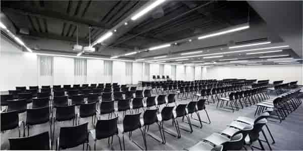 Full Buyout at Convene: modern event space with black chairs for conferences and presentations.