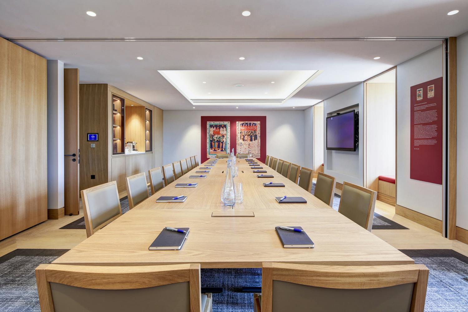 Modern meeting room with wooden table, ideal for professional gatherings and presentations.