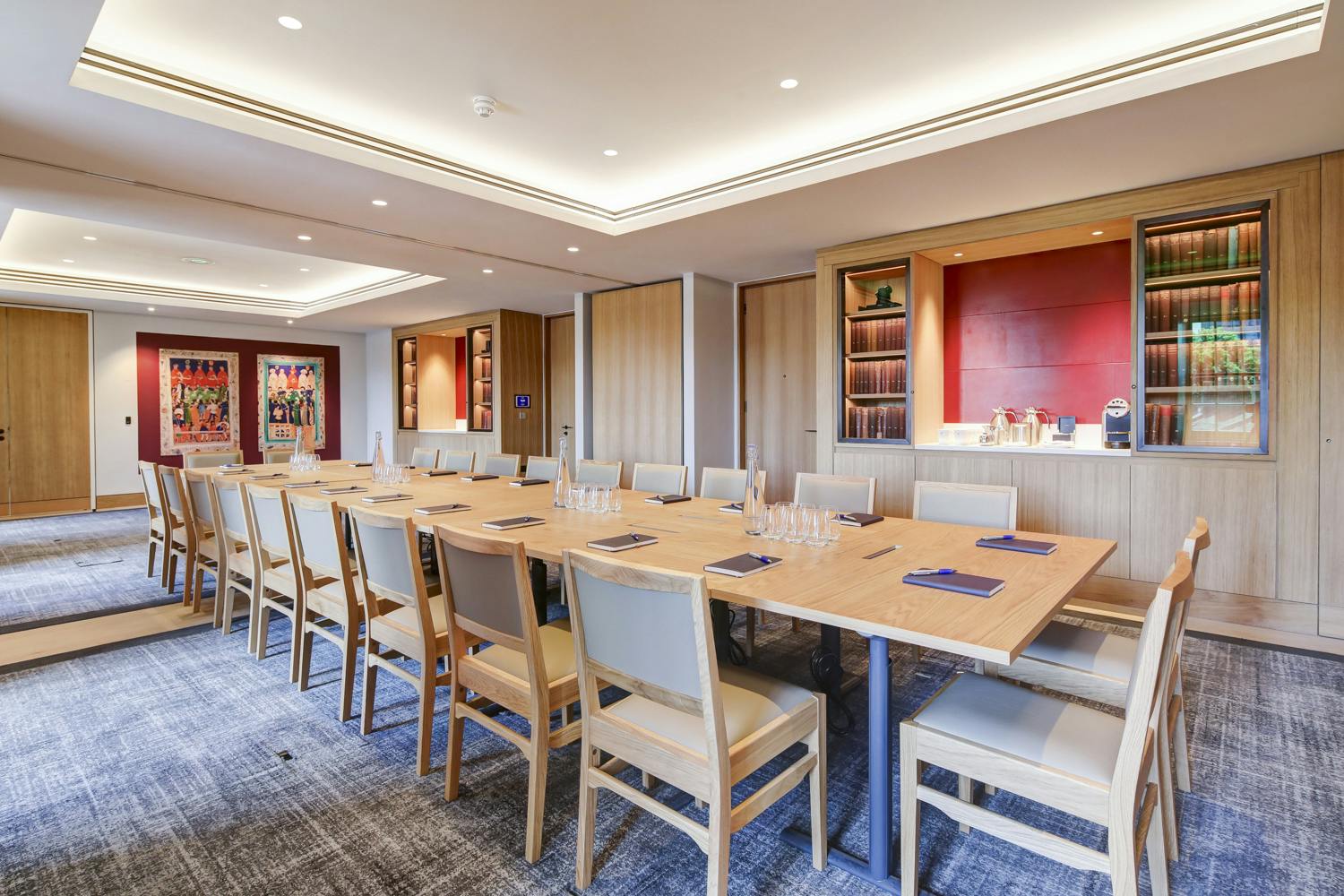 Meeting room with long table, warm wood tones for professional gatherings.