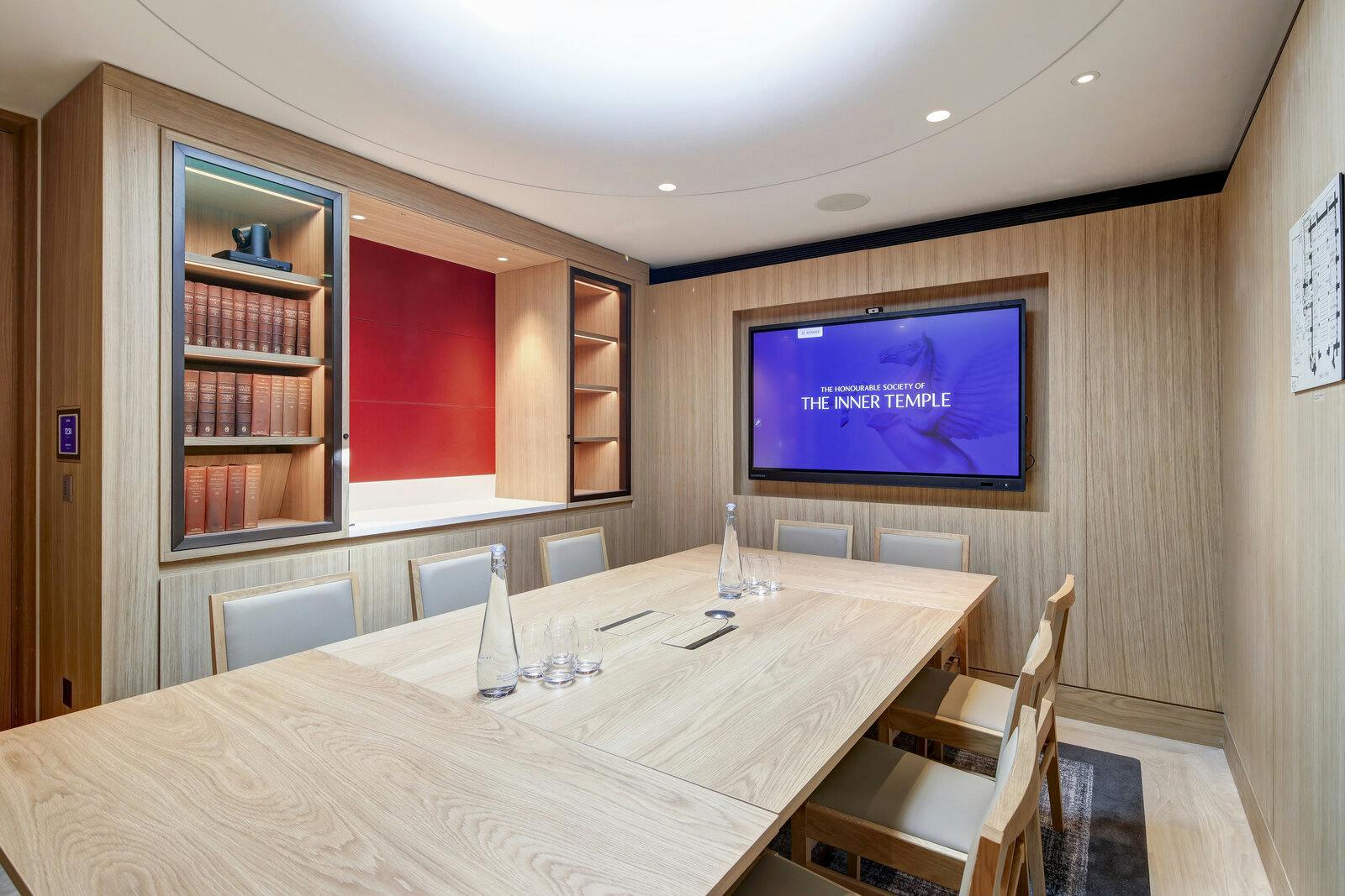 Modern meeting room with wooden table, ideal for conferences and brainstorming sessions.