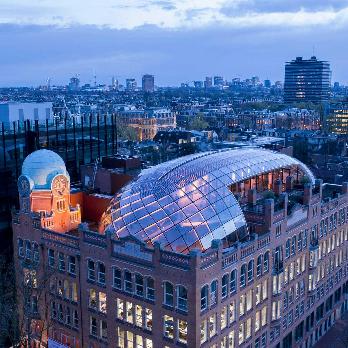 Rooftop venue with glass dome, perfect for upscale events in urban skyline.