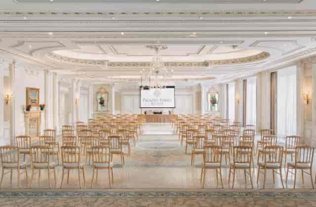 Sala dei Giardini at Palazzo Parigi: elegant conference space with natural light.