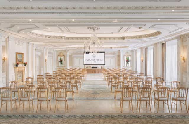 Sala dei Giardini at Palazzo Parigi: elegant conference space with natural light.