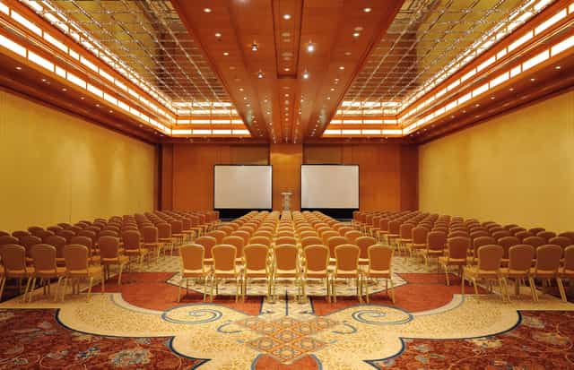 Spacious conference room at Ritz Carlton Dubai for events with elegant decor and seating.