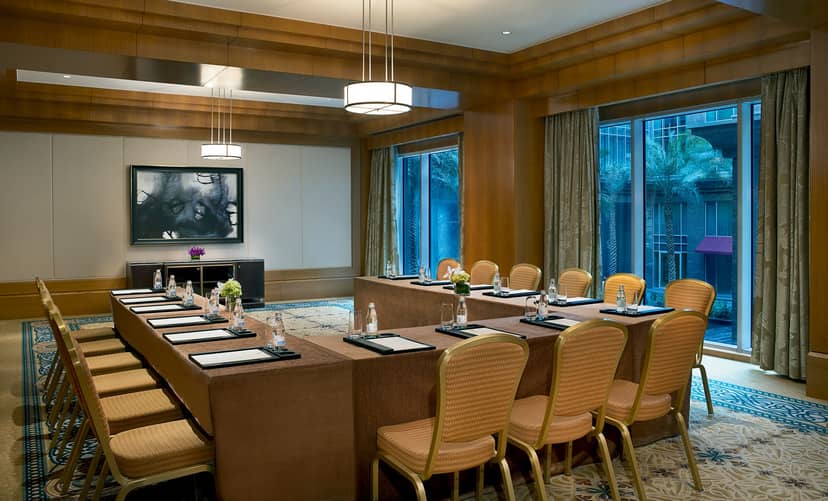 Meeting room at Ritz Carlton Dubai with large table, ideal for corporate events.
