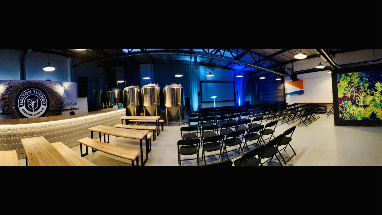 Brewery event space with industrial decor, perfect for corporate meetings and social gatherings.