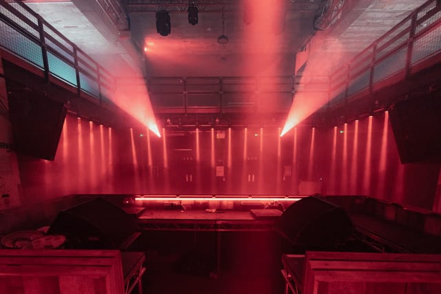 Dynamic event space at Warehouse, featuring red lighting for immersive experiences.