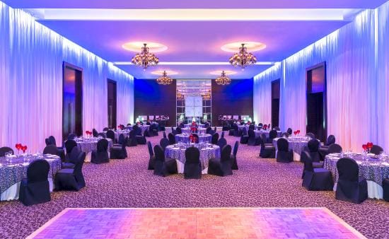 Elegant event space with round tables and dance floor at Le Meridien Dubai Hotel.
